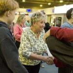 Host family greeting an adult student arriving in Jersey, UK