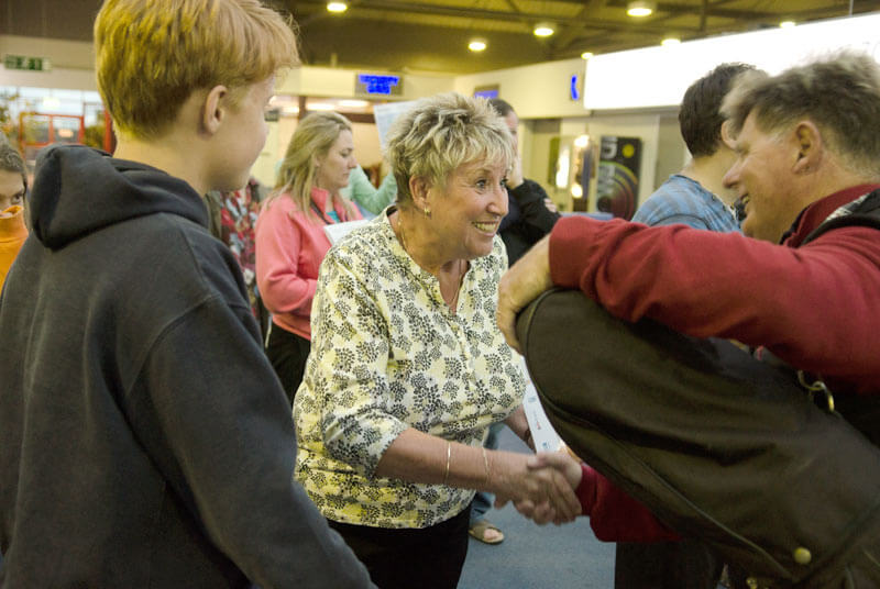 Host family greeting an adult student arriving in Jersey, UK